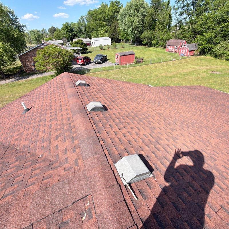 Asphalt shingle roof with vents inspected for damage