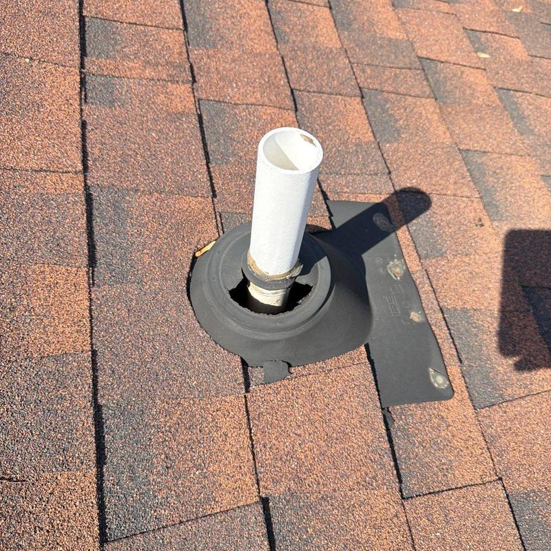 Roof vent flashing with seal damage on asphalt shingles