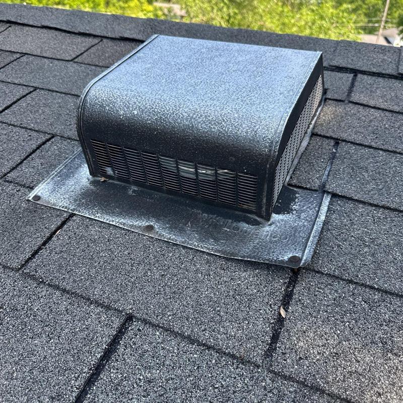 Roof vent with metal flashing on asphalt shingles