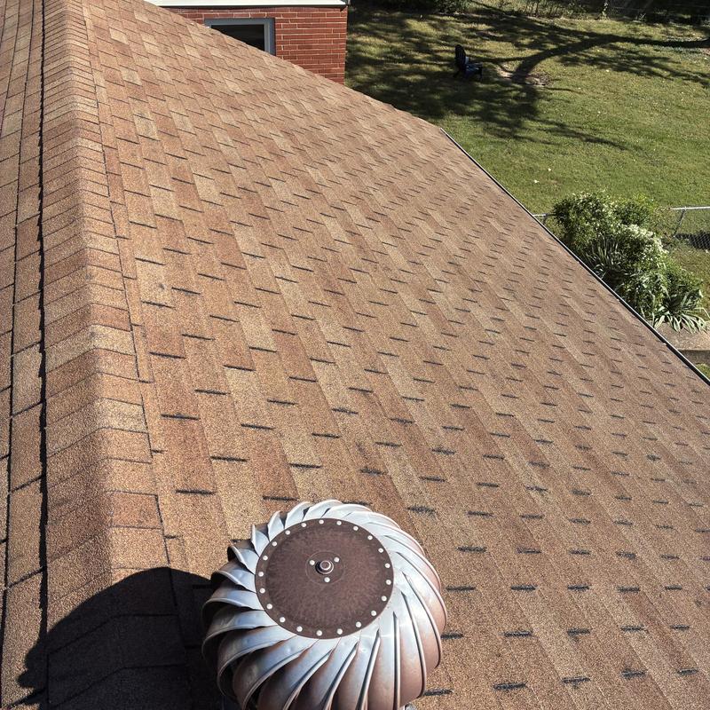 Asphalt shingle roof with ventilation turbine and hail damage