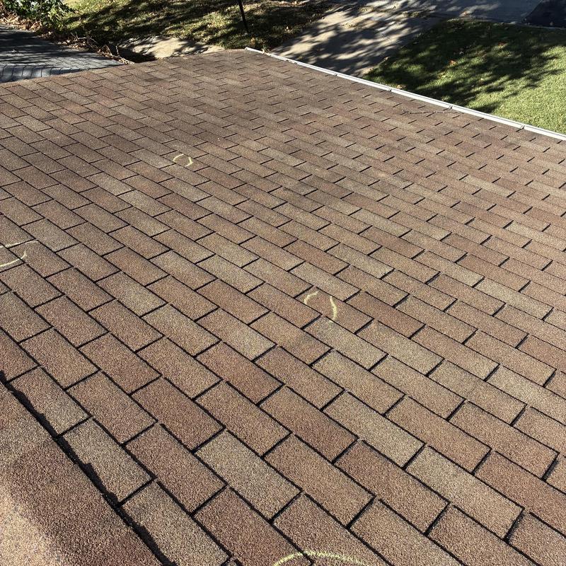 Asphalt shingle roof with hail damage and markings