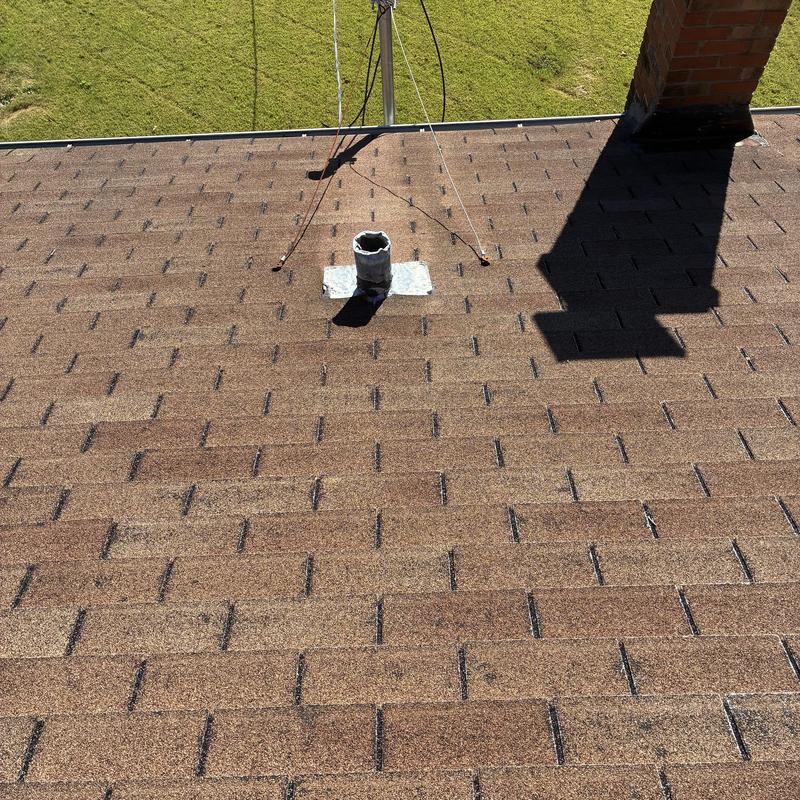 Roof shingles with hail damage and blistering near vent pipe