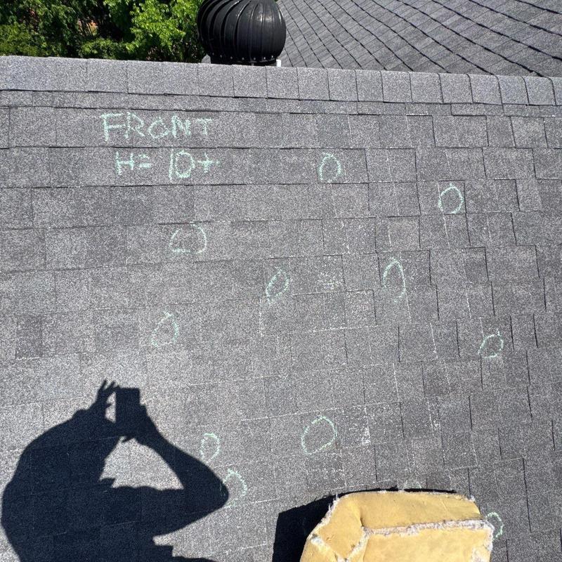 Asphalt shingle roof with hail damage markings