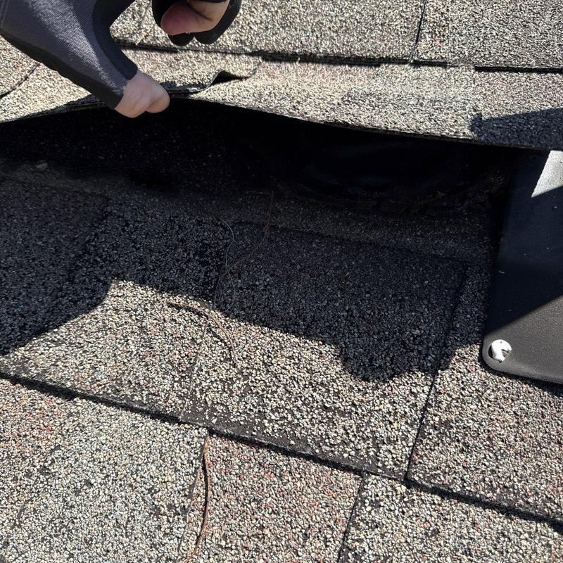 Roof shingles lifted for hail damage inspection