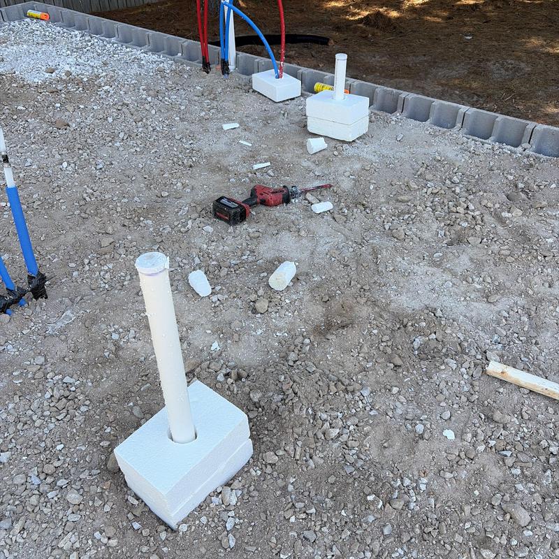 Water and sewer service piping with protective foam blocks