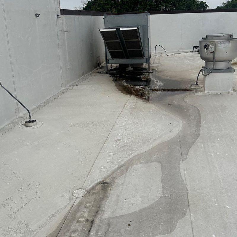 Concrete commercial roof with water pooling and wear Concrete commercial roof with water pooling and wear