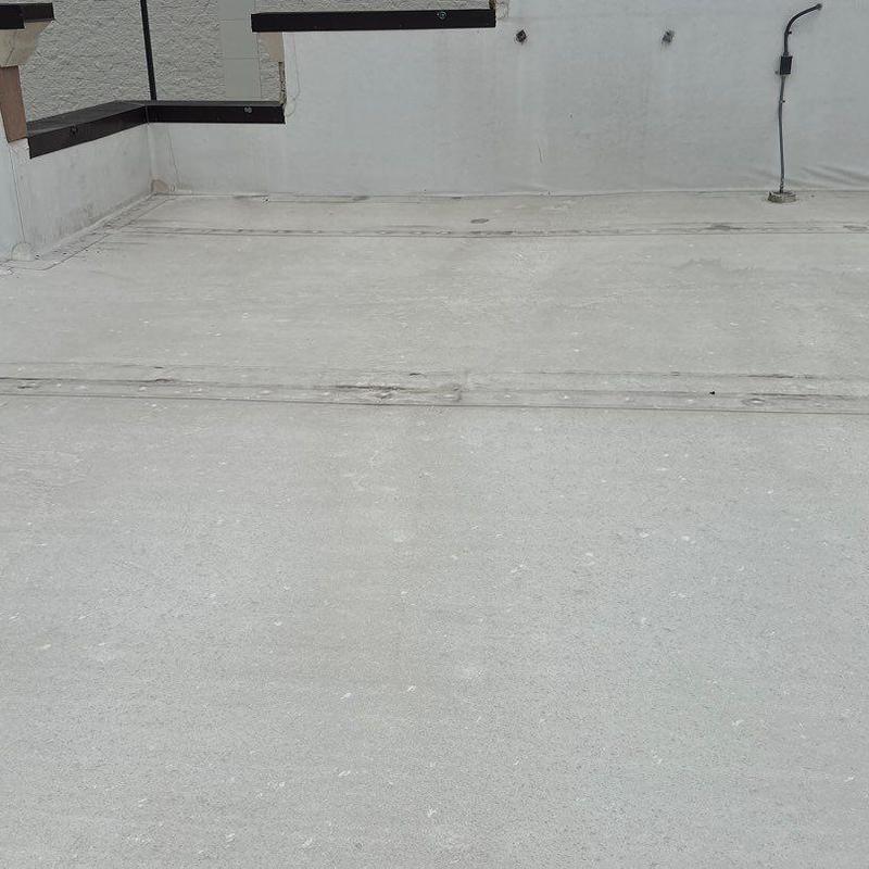 Concrete commercial roof surface with sealing repairs Concrete commercial roof surface with sealing repairs