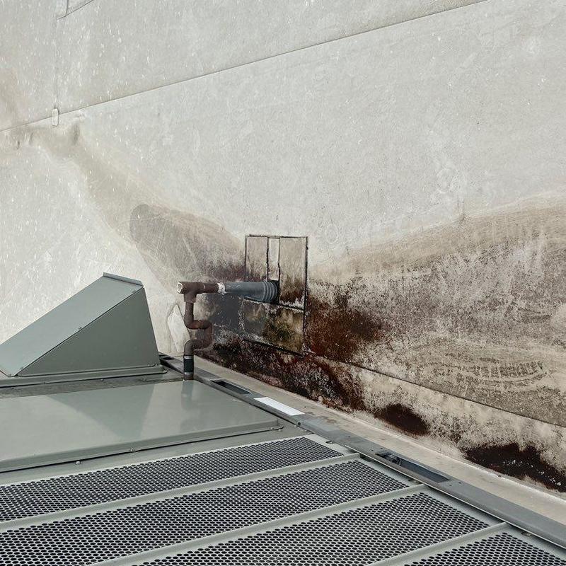 Concrete roof with water damage and ventilation pipe Concrete roof with water damage and ventilation pipe