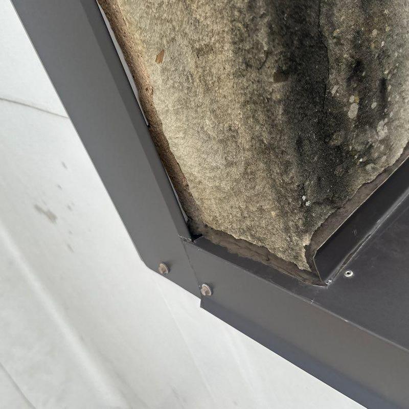 Concrete roof edge with metal flashing and damage Concrete roof edge with metal flashing and damage