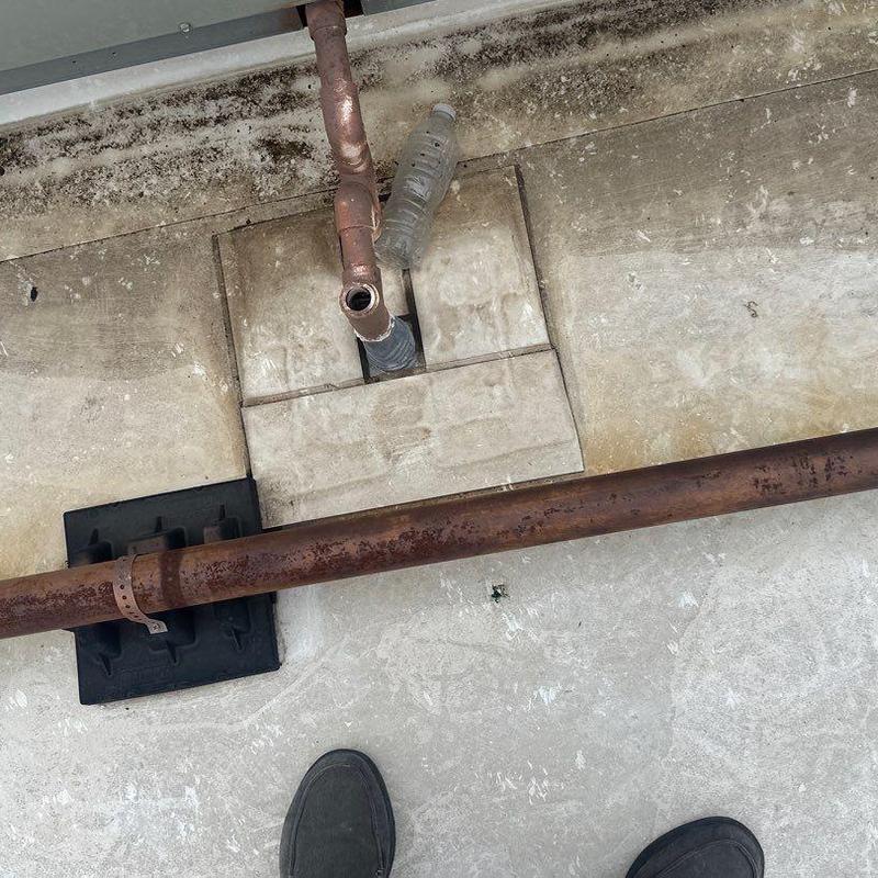 Concrete roof section with exposed rusty pipes Concrete roof section with exposed rusty pipes