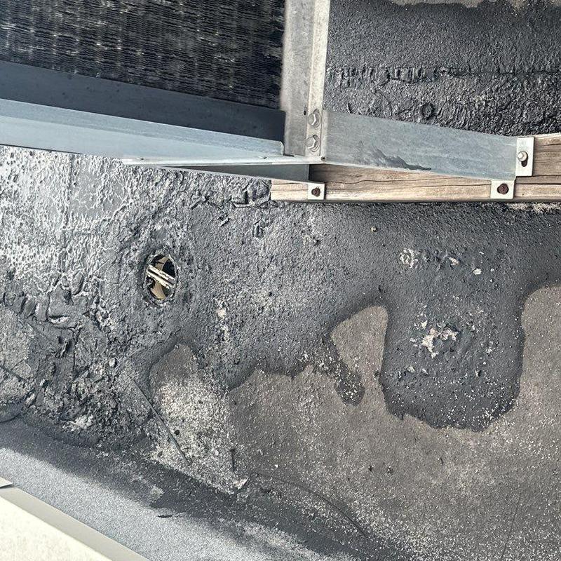 Concrete roof surface with leak damage and metal flashing Concrete roof surface with leak damage and metal flashing