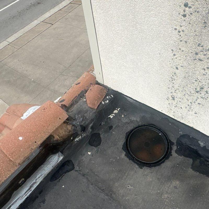 Concrete roof corner with repaired flashing and drain Concrete roof corner with repaired flashing and drain
