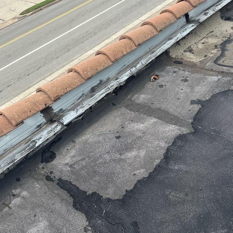 Concrete roof surface with repair patches near tile edge Concrete roof surface with repair patches near tile edge