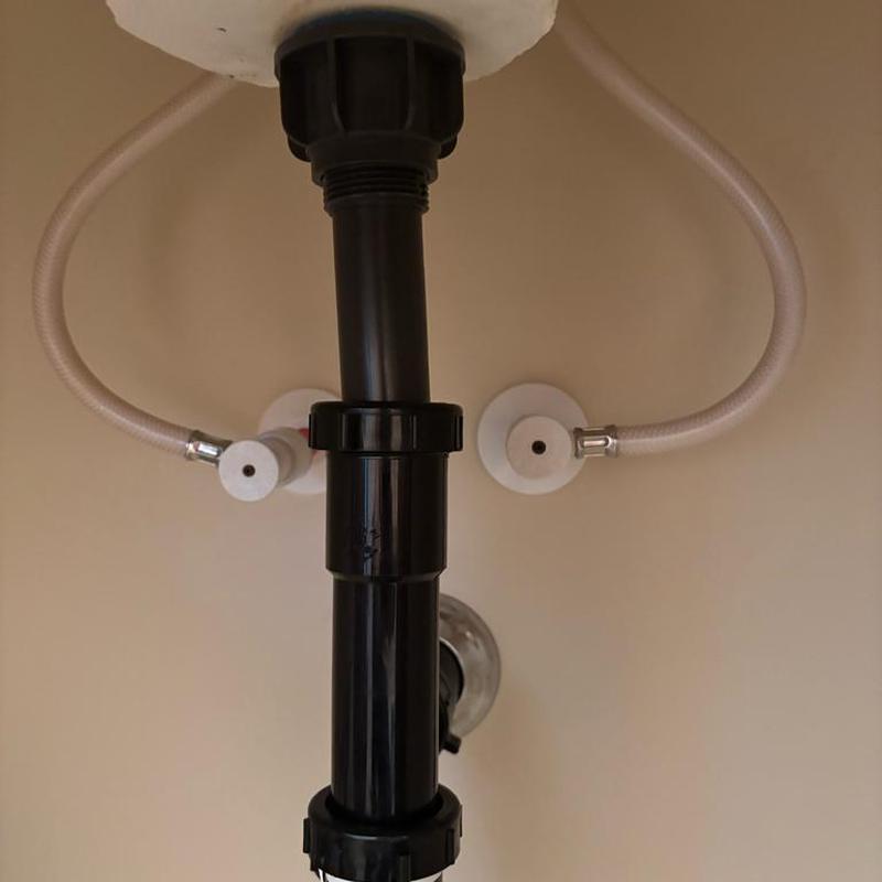 Bathroom sink drain and supply line installation under sink