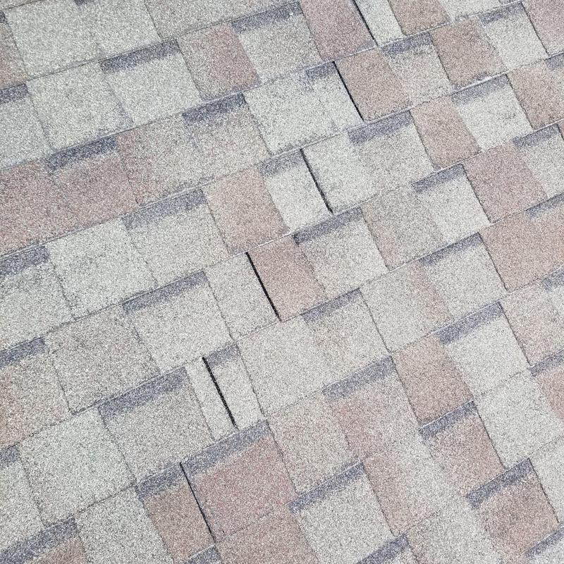 Shingle roof with cracked tiles after storm damage Shingle roof with cracked tiles after storm damage