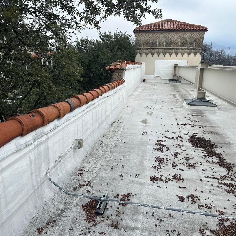 Concrete roof surface with tile railing at commercial building Concrete roof surface with tile railing at commercial building