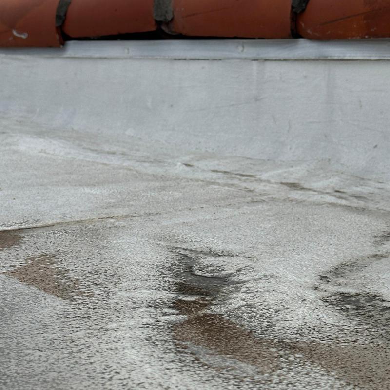 Concrete roofing surface with water pooling and damage Concrete roofing surface with water pooling and damage