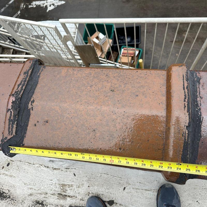 Concrete roof tile with sealant repair and measuring tape Concrete roof tile with sealant repair and measuring tape