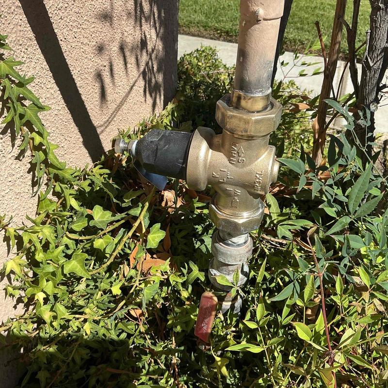 Pressure regulator valve with attached piping outdoors