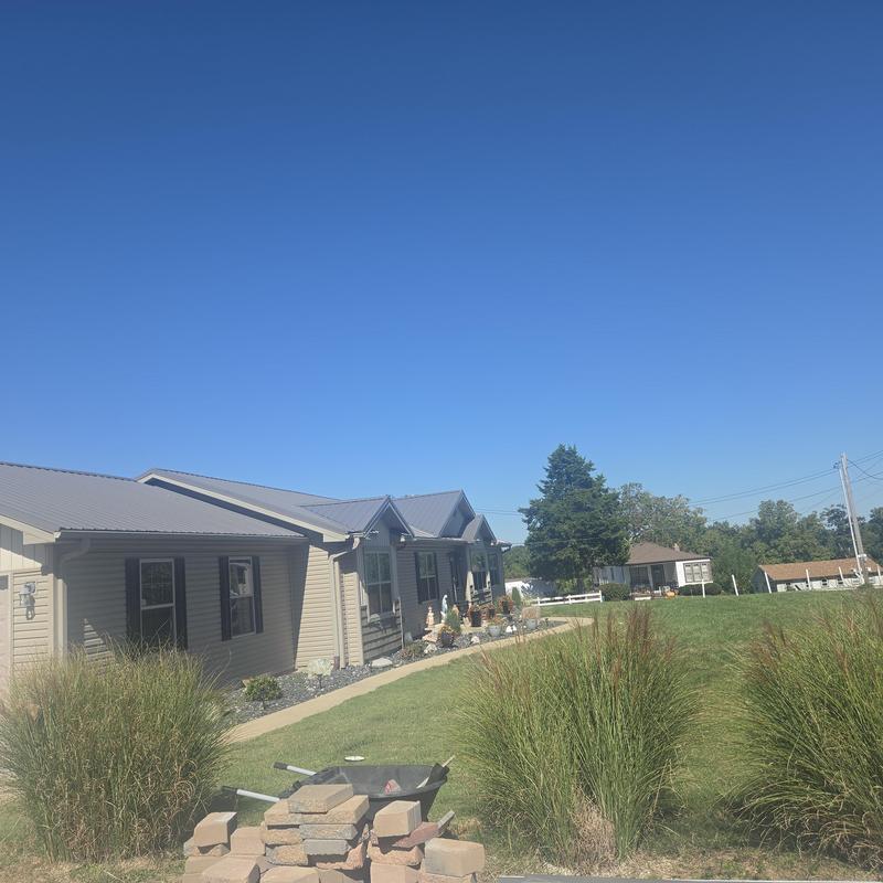 Metal roofing with exposed fasteners on residential home
