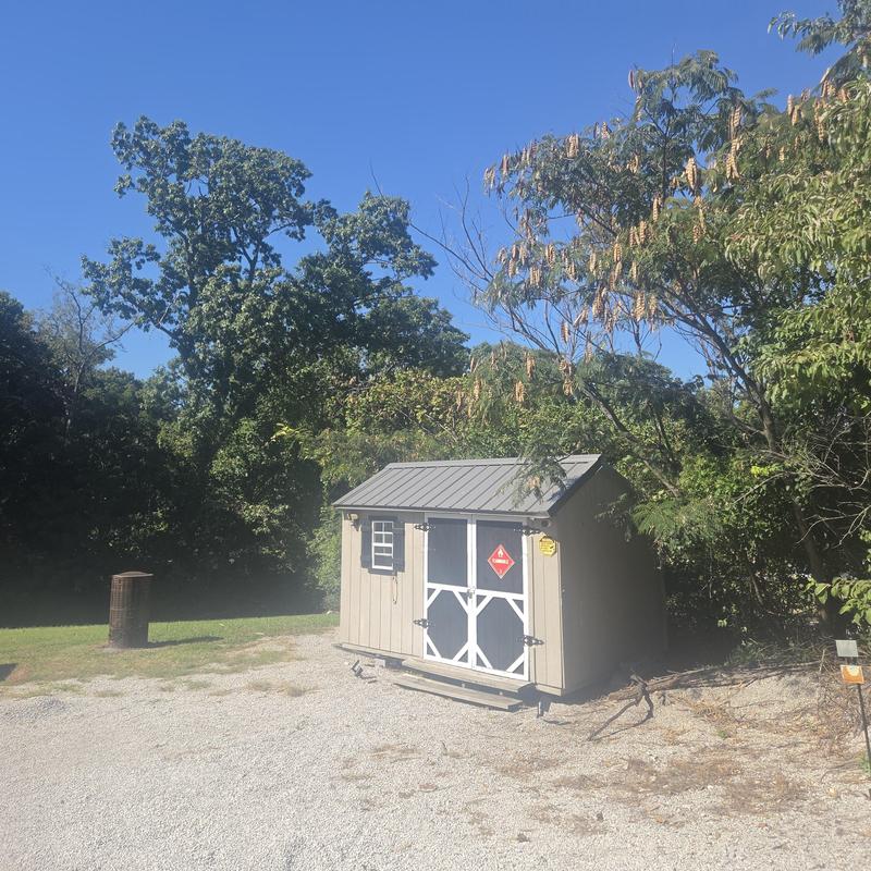 Metal roofing on outdoor storage shed with gravel base
