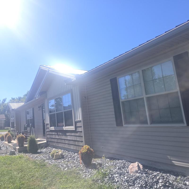 Metal roofing with exposed fasteners and synthetic felt