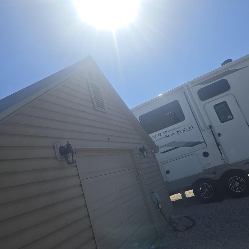 Metal roofing panels on residential garage under bright sun