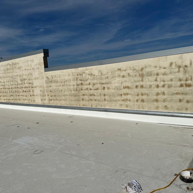 Concrete block wall weathering and discoloration on roof Concrete block wall weathering and discoloration on roof