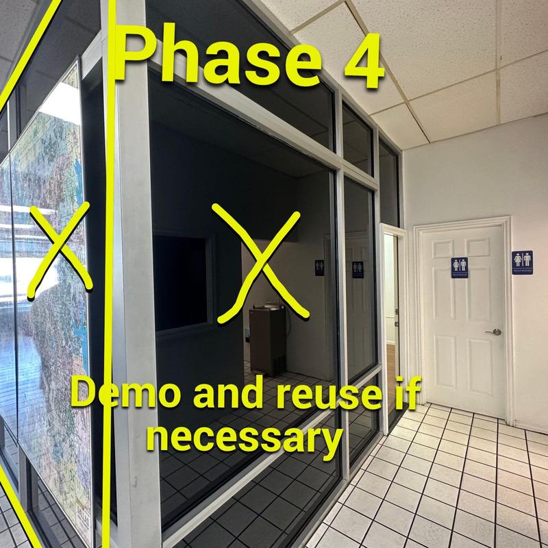 Glass office partitions marked for demo and reuse Glass office partitions marked for demo and reuse