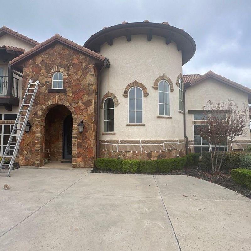 Stucco exterior repainting with stone accents at home Stucco exterior repainting with stone accents at home