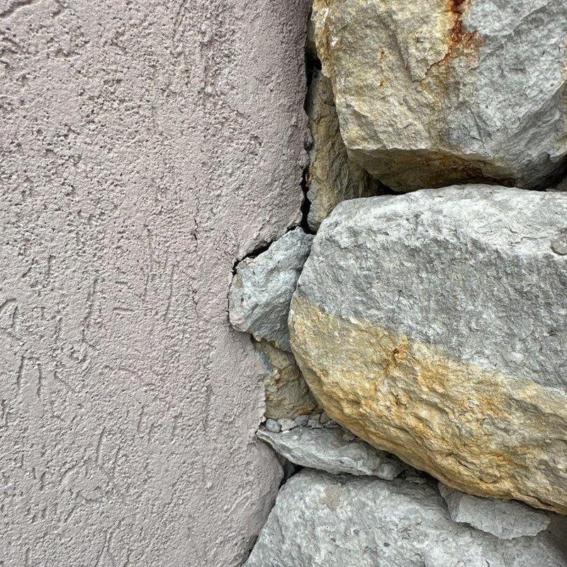 Stucco and stone exterior corner with cracking detail Stucco and stone exterior corner with cracking detail