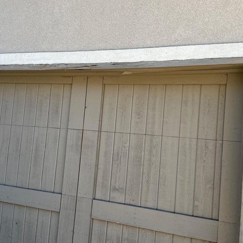 Stucco trim above wooden garage door paneling Stucco trim above wooden garage door paneling