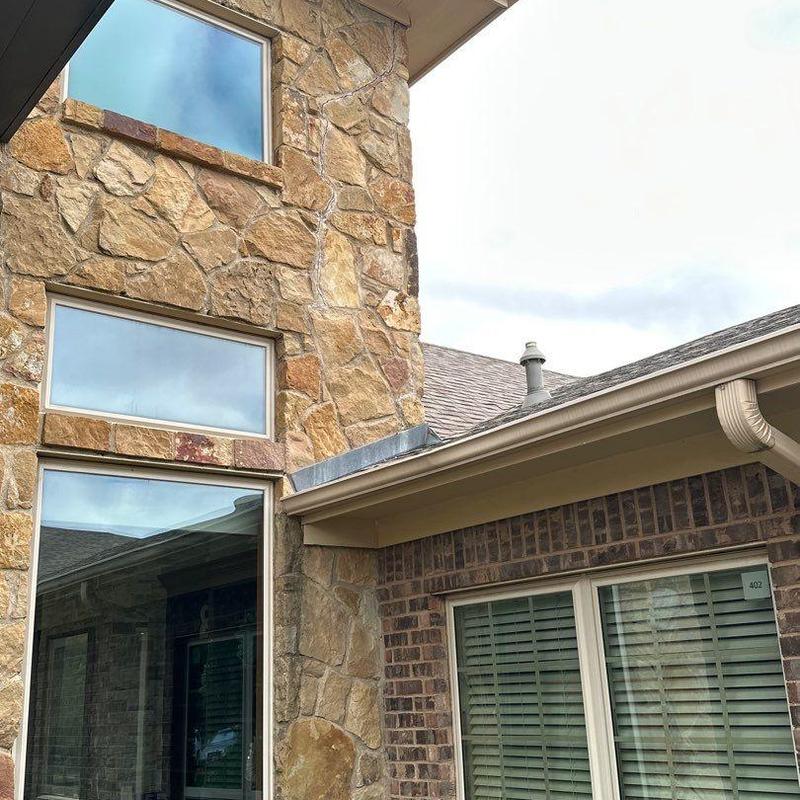 Stone veneer exterior with masonry repair near roofline Stone veneer exterior with masonry repair near roofline