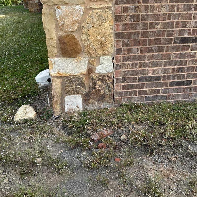 Stone veneer corner and brick junction exterior wall Stone veneer corner and brick junction exterior wall