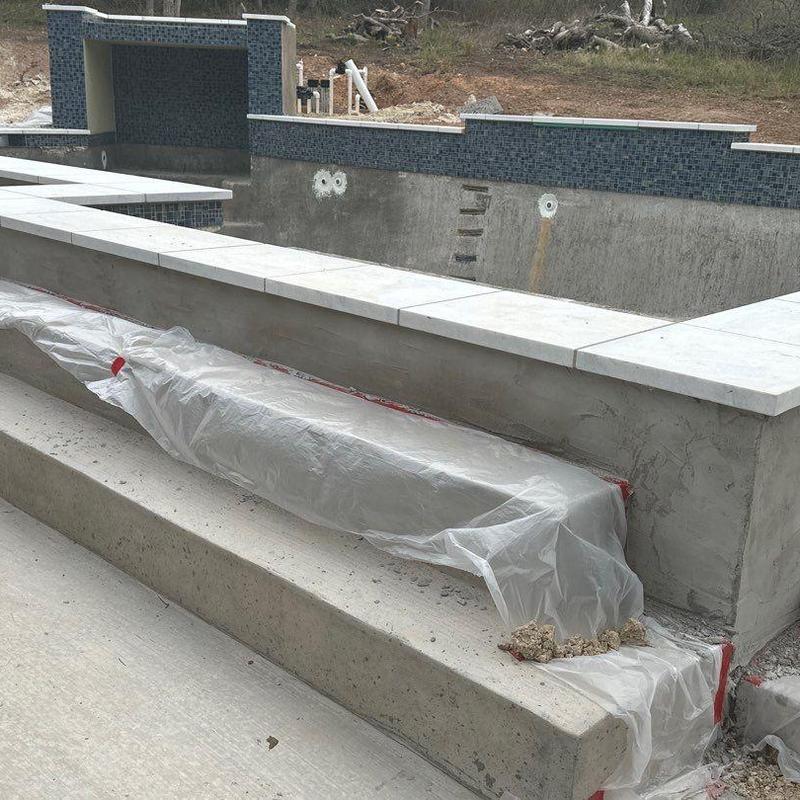 Pool blue mosaic tile and concrete coping installation Pool blue mosaic tile and concrete coping installation
