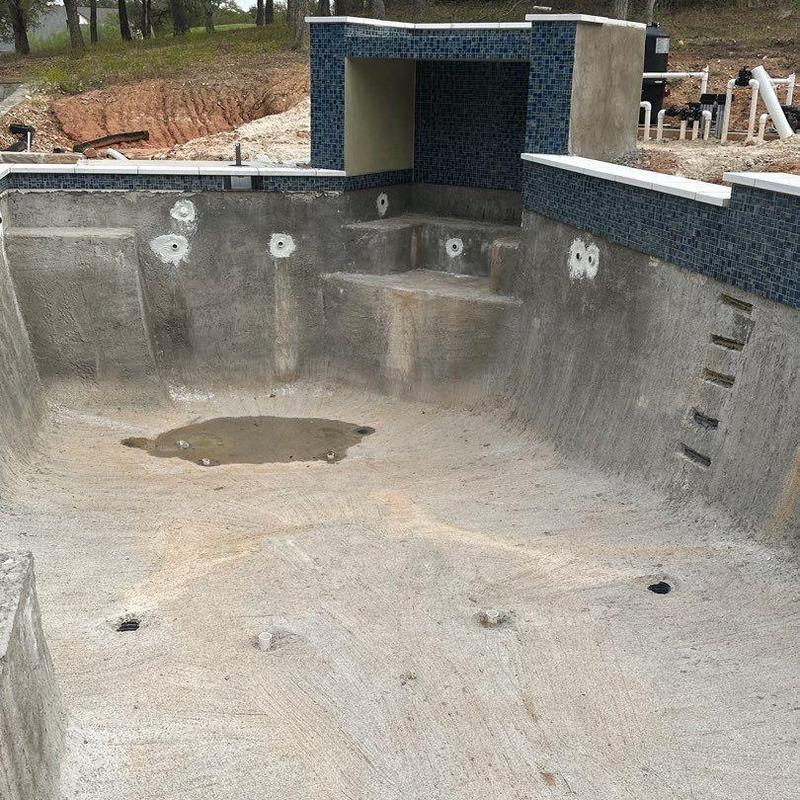 Concrete pool shell with blue mosaic tile walls Concrete pool shell with blue mosaic tile walls