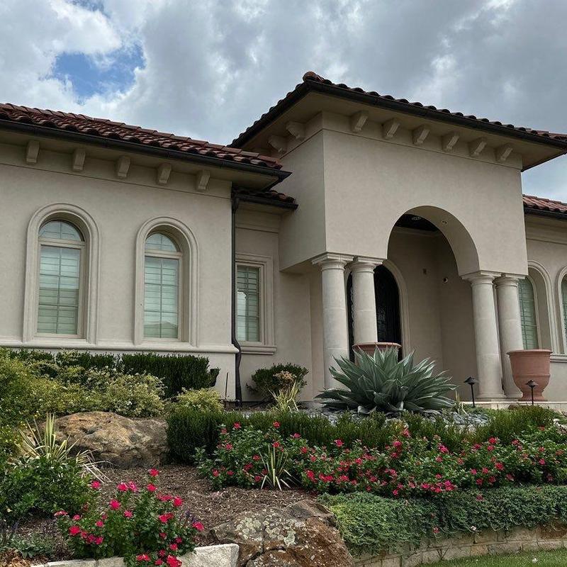 Stucco exterior finish with arched windows and columns Stucco exterior finish with arched windows and columns
