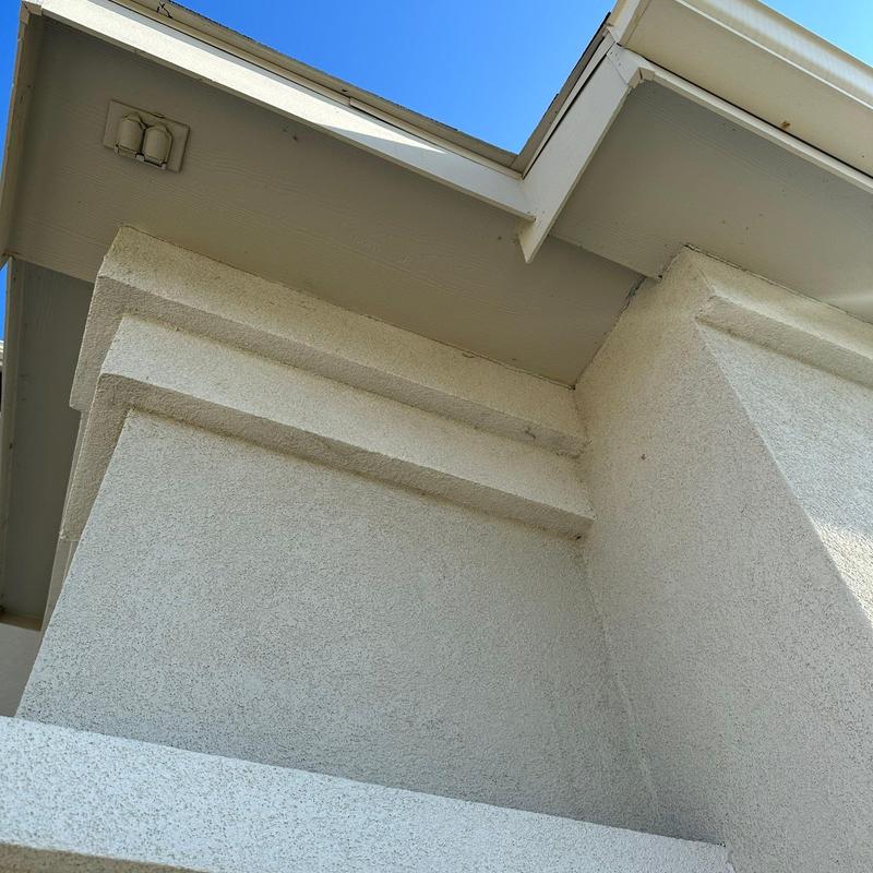Stucco patching on exterior wall and trim details Stucco patching on exterior wall and trim details