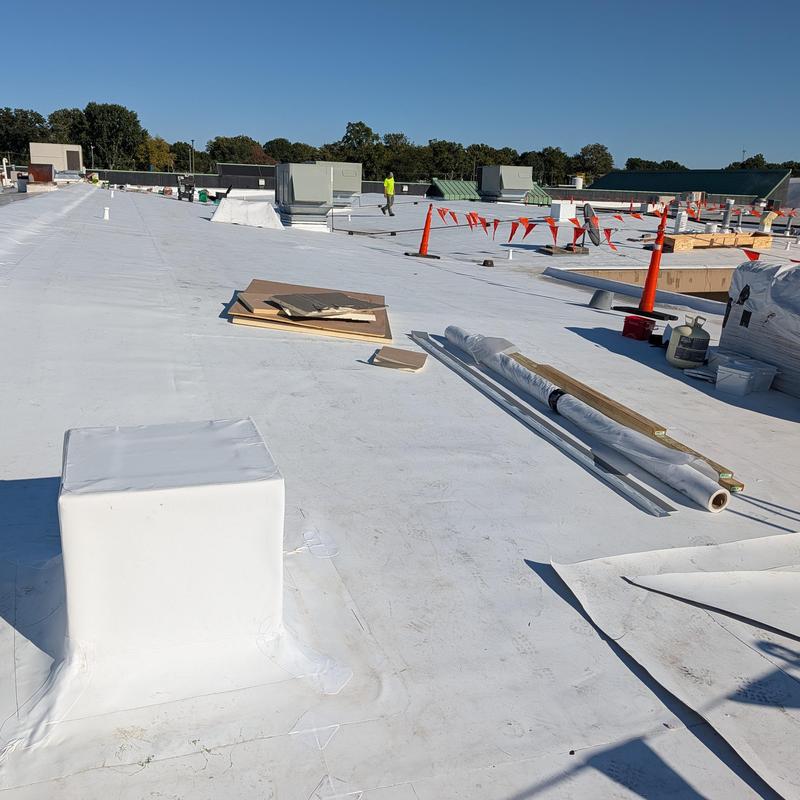 Commercial white TPO roofing membrane installation