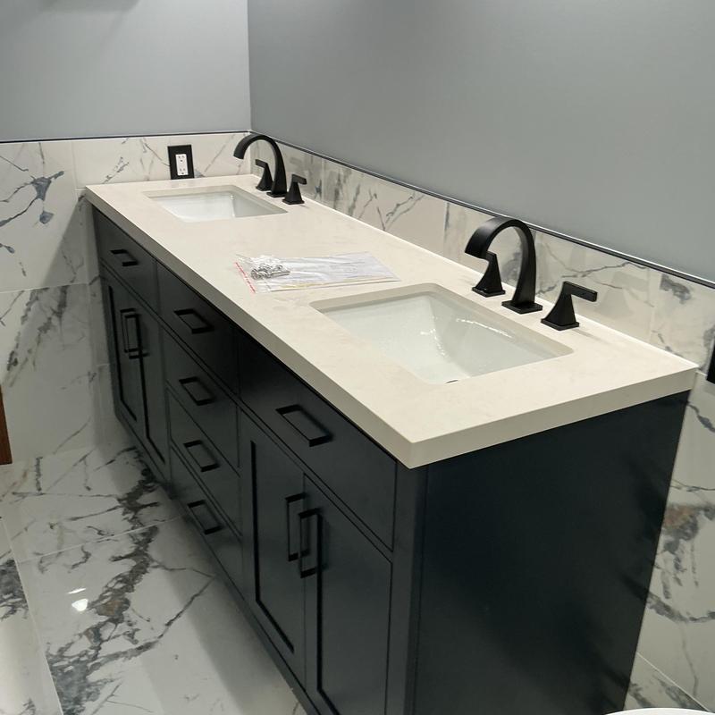 Double sink vanity with black faucets in remodeled bathroom