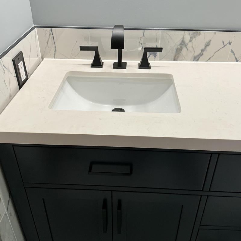 Bathroom sink faucet and countertop with dark vanity