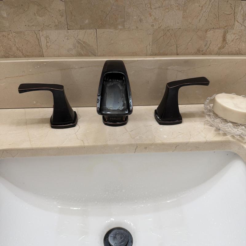Bathroom sink faucet with black finish and soap dish