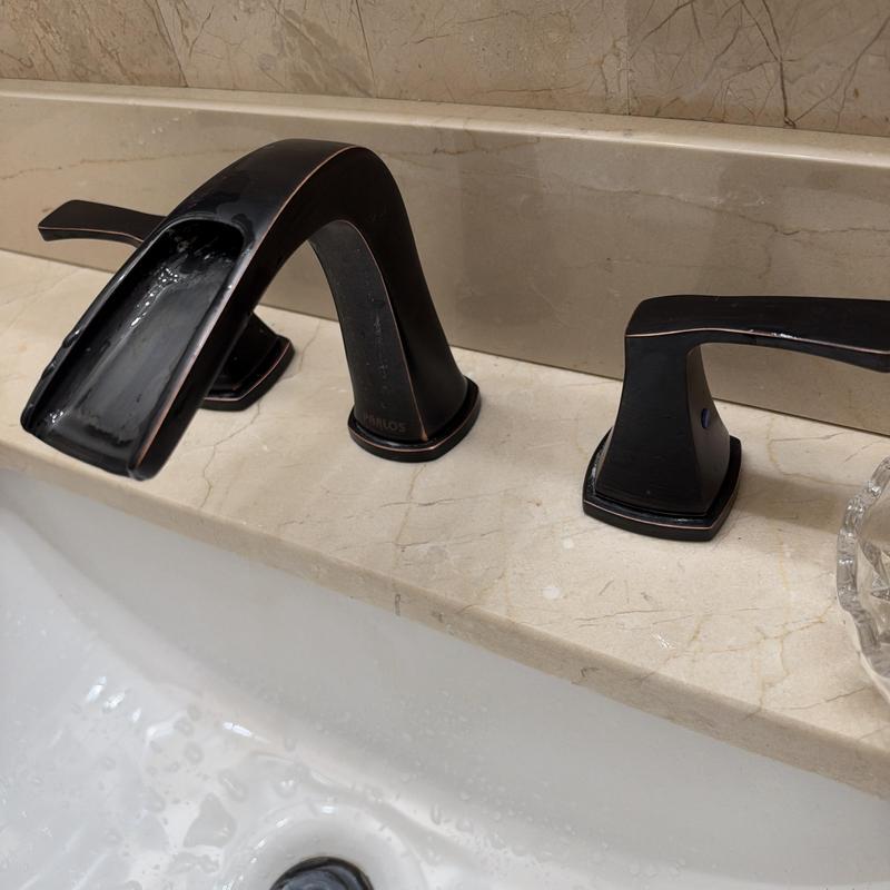 Waterfall bathroom sink faucet and handles on marble
