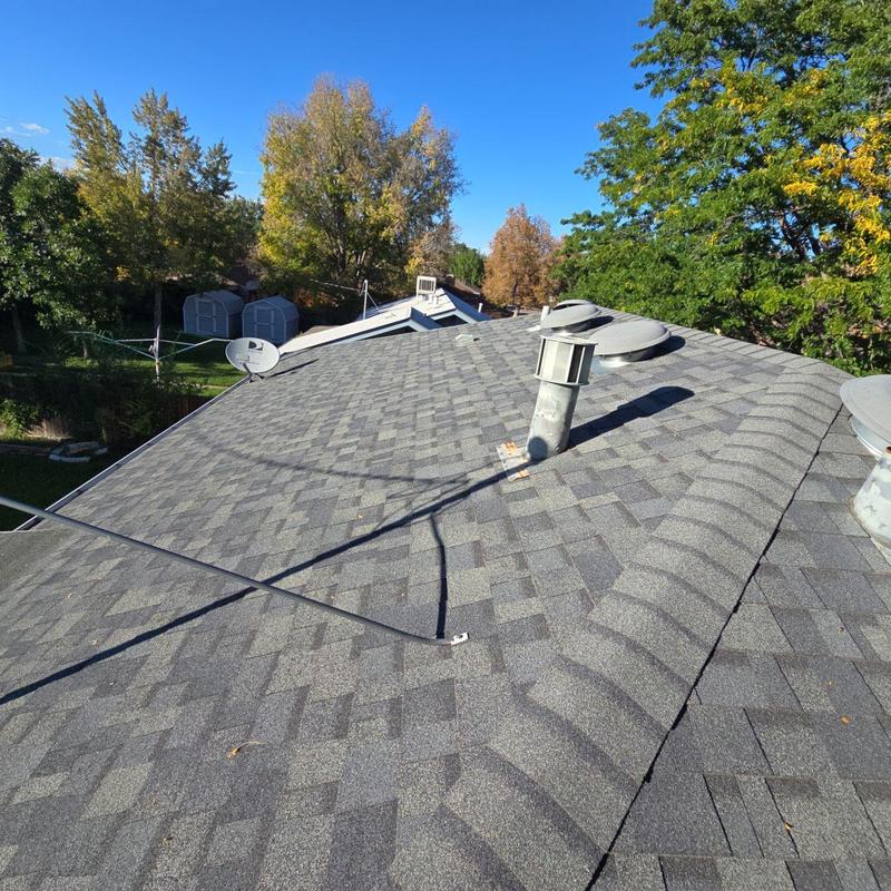 Asphalt shingle roof with vent pipes and satellite dish
