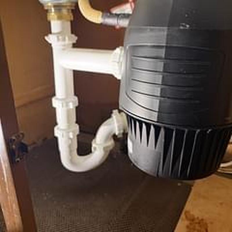 Garbage disposer and drain piping under kitchen sink