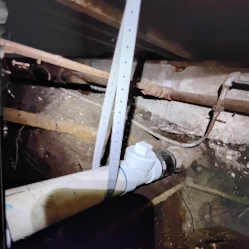PVC sewer pipe replacing broken cast iron under home