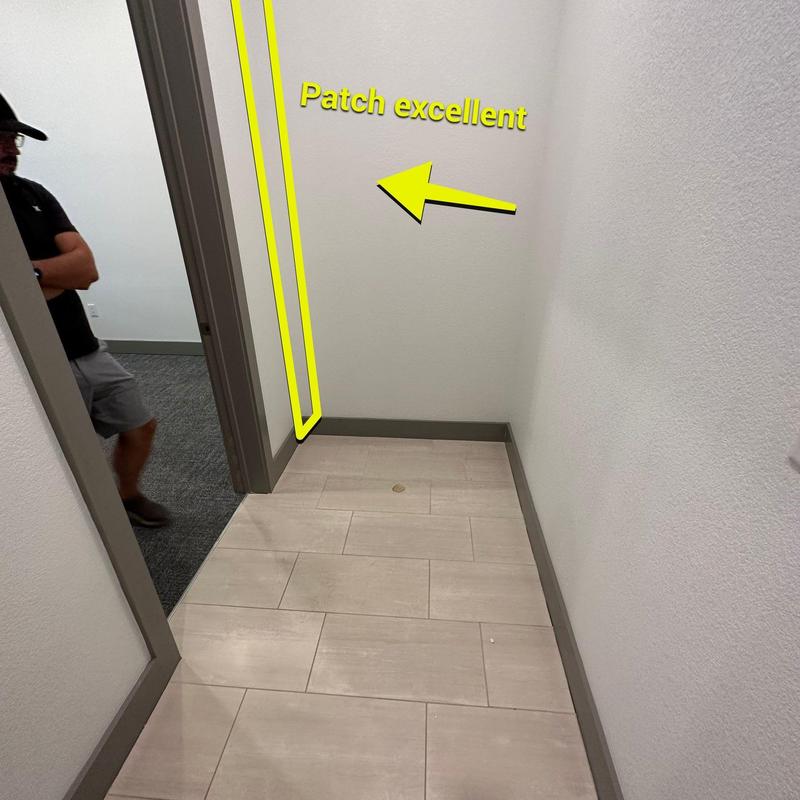Drywall corner patch with smooth finish in hallway Drywall corner patch with smooth finish in hallway