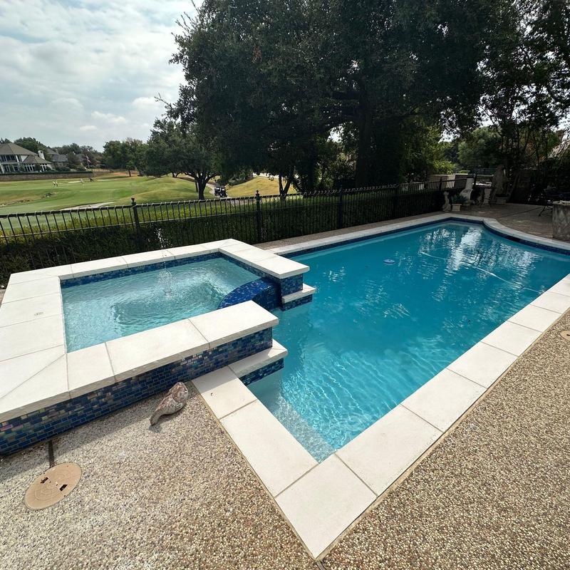 Concrete pool and spa surround with tile coping Concrete pool and spa surround with tile coping