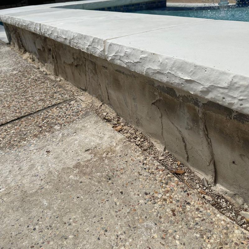 Pool concrete surround with white coping and blue tile Pool concrete surround with white coping and blue tile