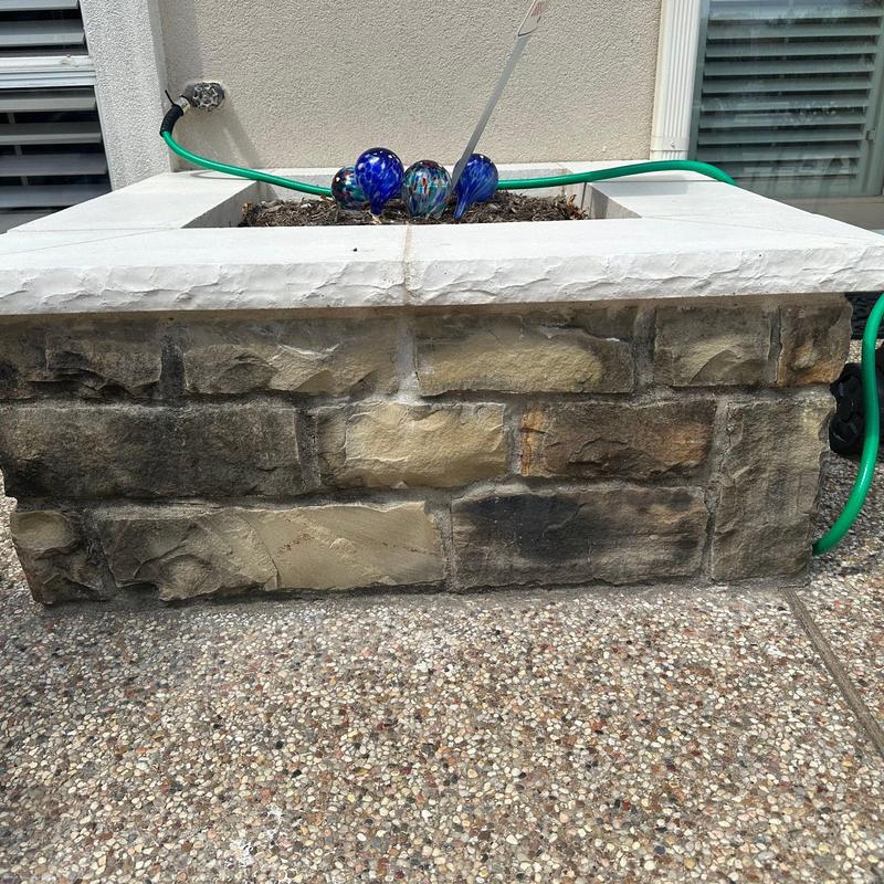 Stone planter box with decorative glass balls Stone planter box with decorative glass balls